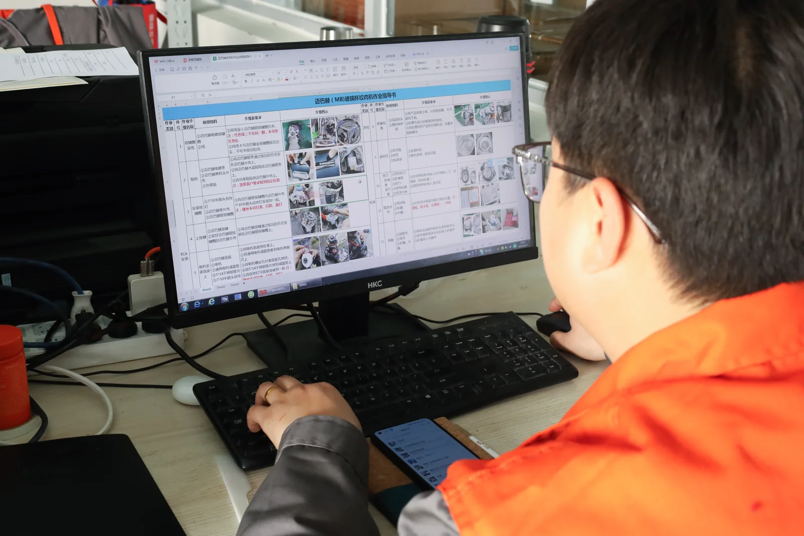 JINJIE production team reviewing an appliance assembly work instruction