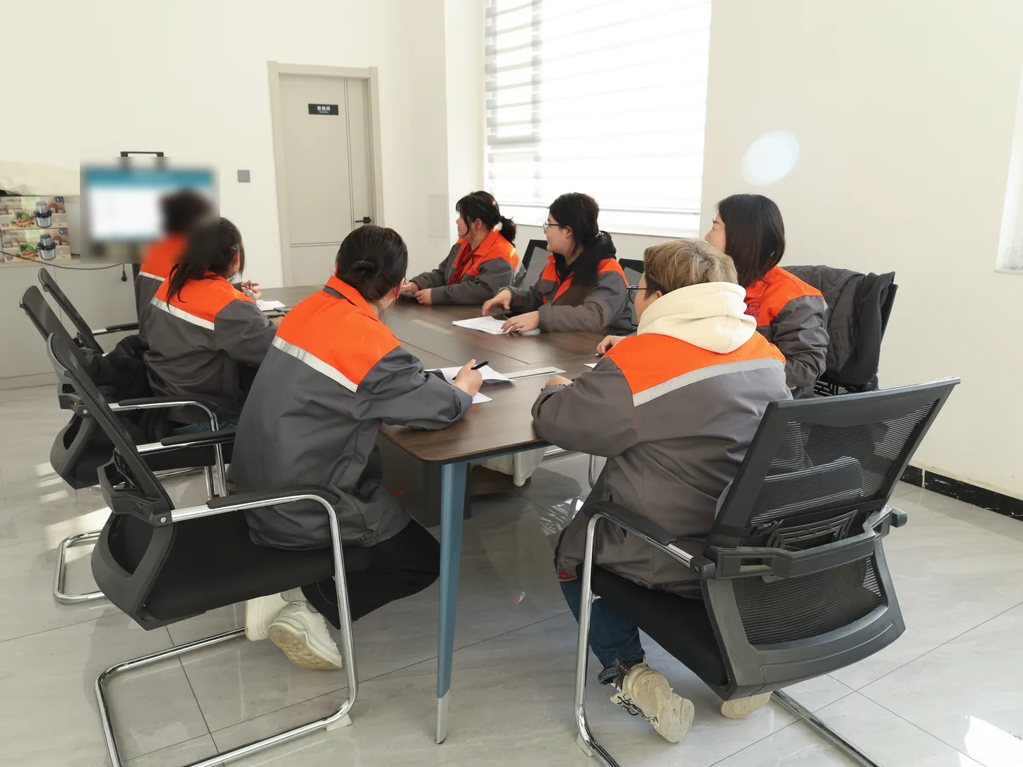 JINJIE team reviewing project information and printed records before production preparation