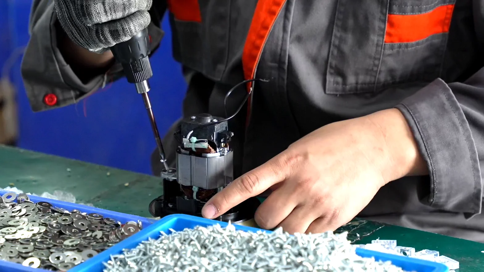 JINJIE worker assembling a small kitchen appliance