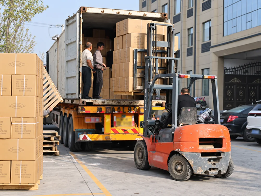 Forklift and cartons beside an open shipping container during loading preparation