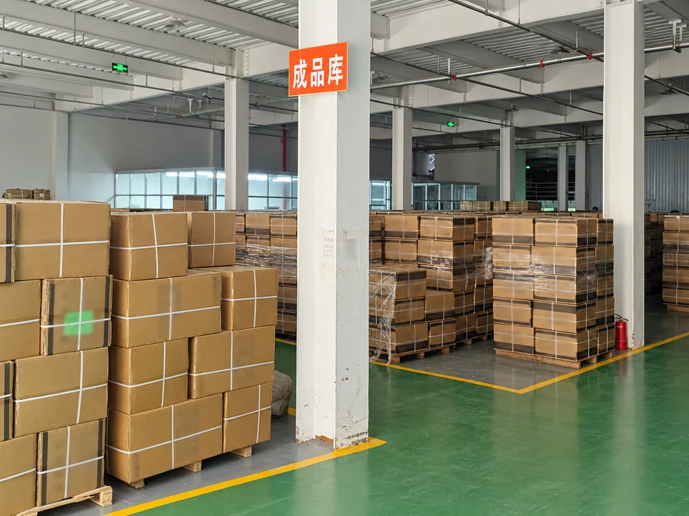 Strapped cartons on pallets in the factory's marked finished-goods area