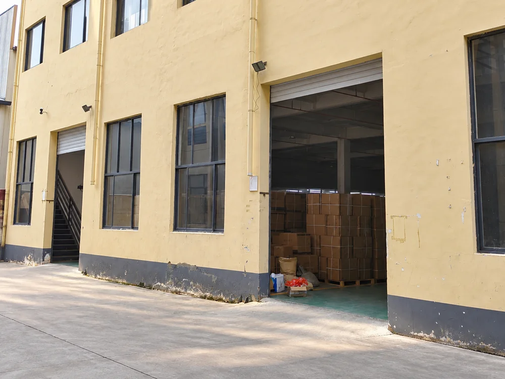 Open warehouse doorway with cartons inside the actual factory building