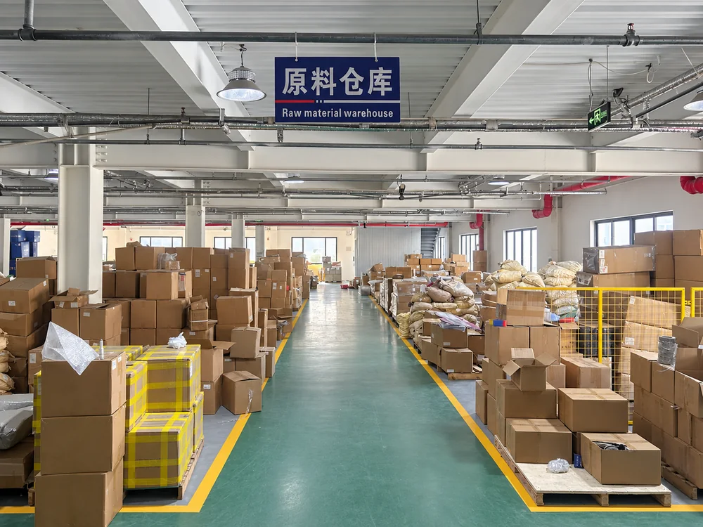 Marked central aisle between cartons and bags in JINJIE's raw material warehouse