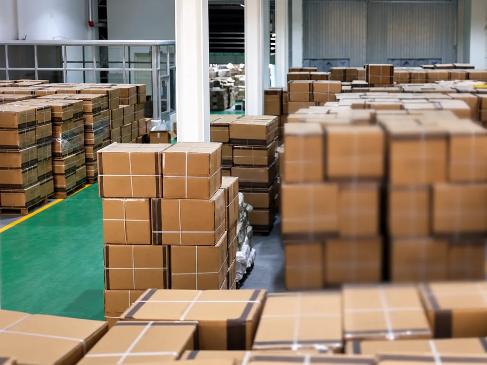 Carton stacks beside an aisle in JINJIE's warehouse