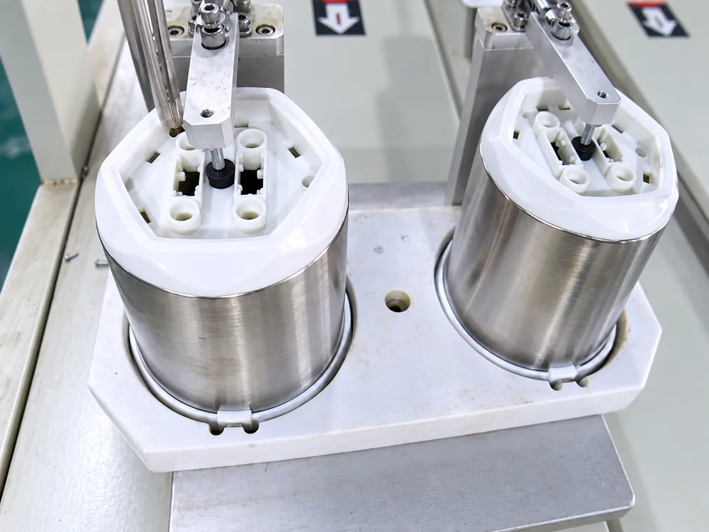 Two motor housings held in an assembly fixture at JINJIE