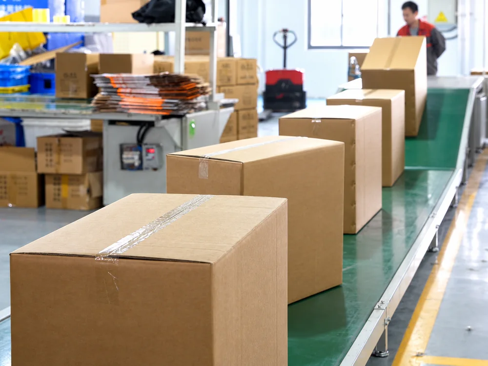 Sealed cartons moving through JINJIE's packing area