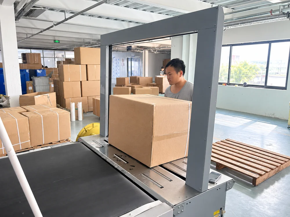 Carton at a factory strapping station