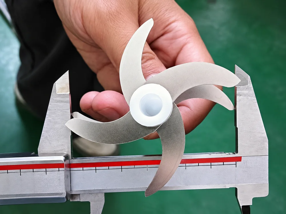 Blade assembly between caliper jaws in a close-up inspection scene