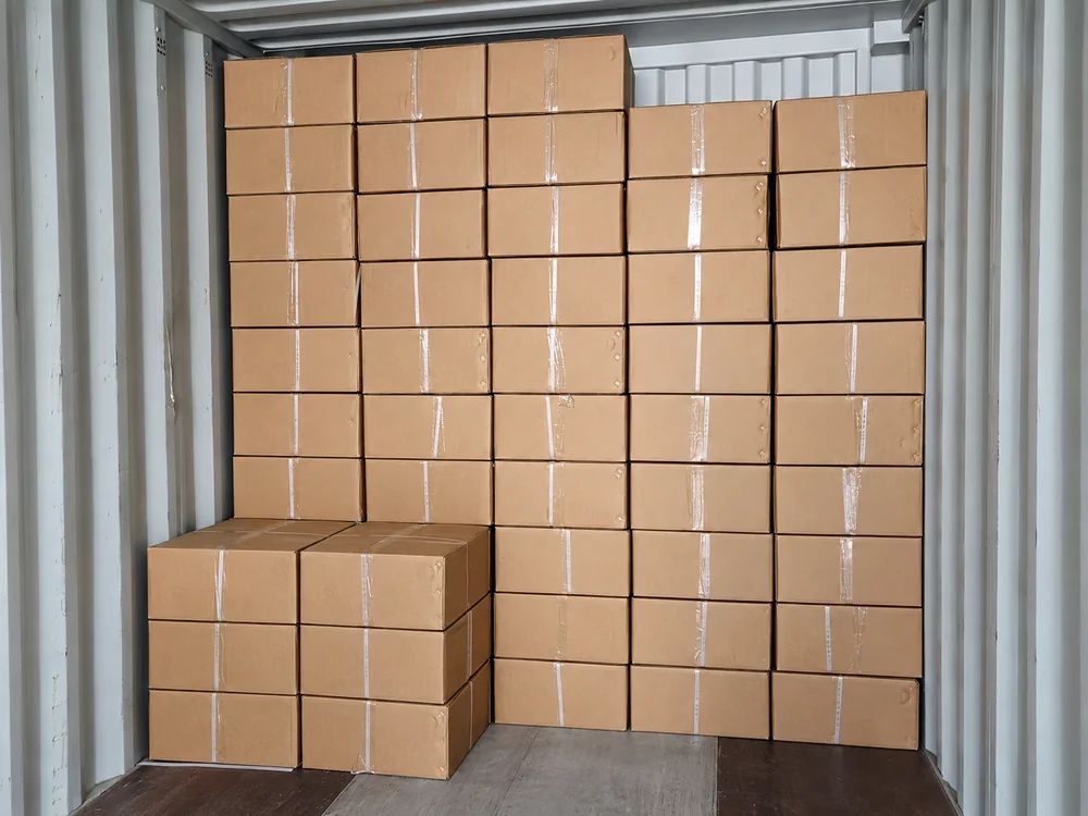 Cartons stacked inside a shipping container