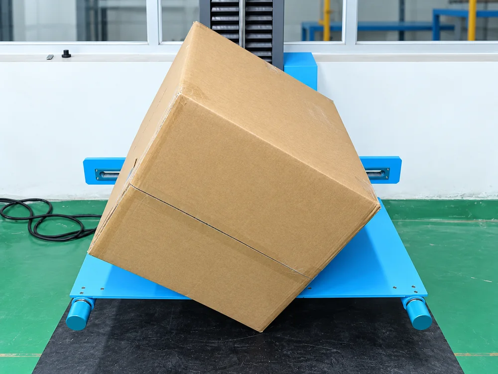 Carton positioned on blue drop-test equipment