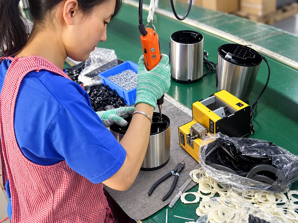Operator working with appliance components at an assembly bench