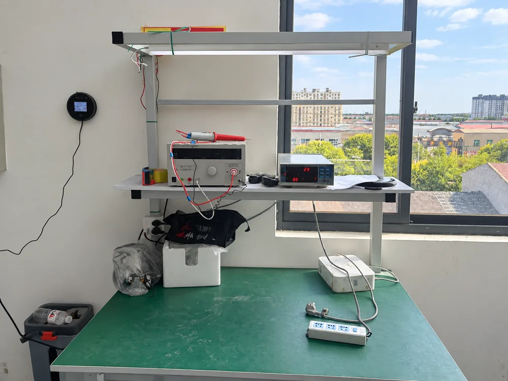 Inspection instruments on a real factory workbench beside a window